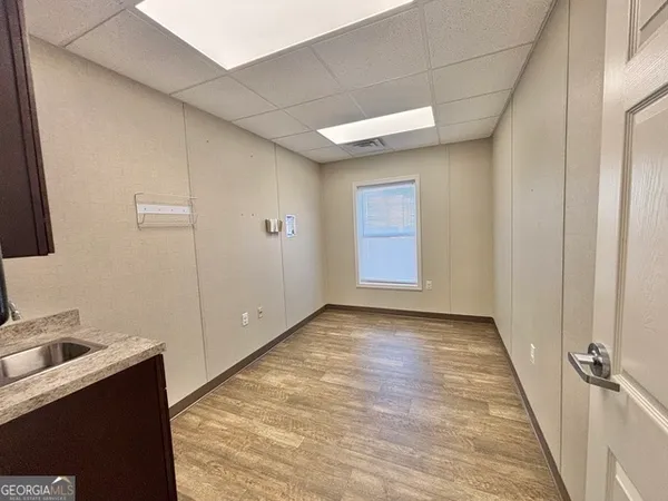 a view of a room with a sink and cabinets