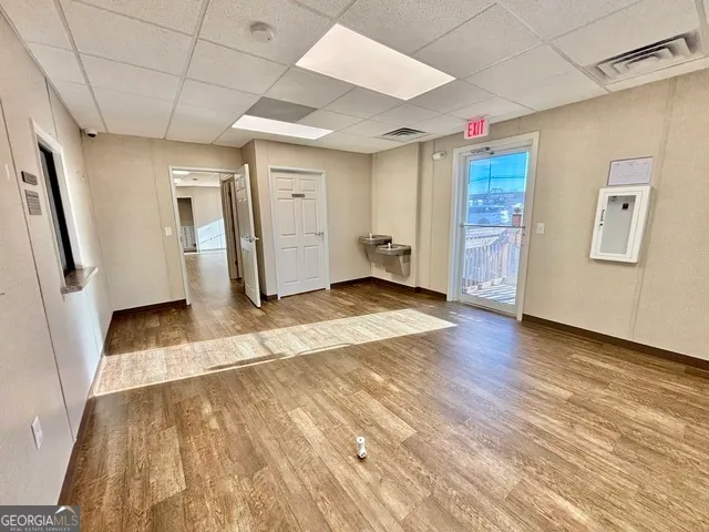 a view of a hallway with wooden floor and closet