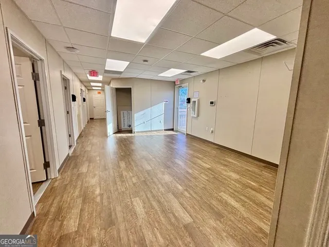 a view of a hallway with wooden floor