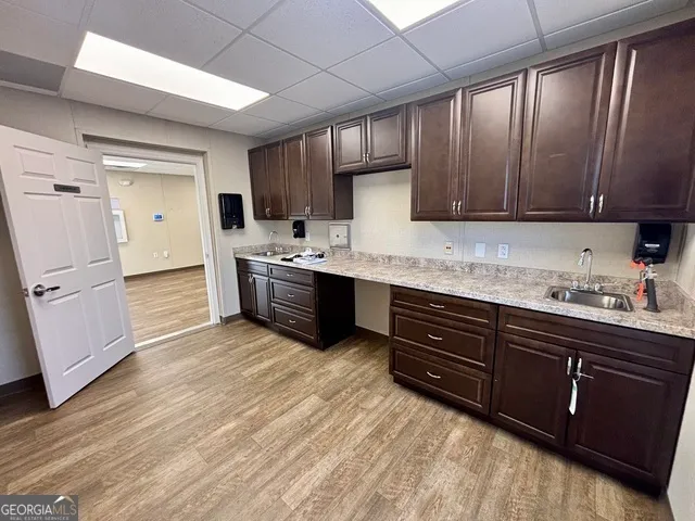 a kitchen with stainless steel appliances granite countertop wooden cabinets a sink and dishwasher