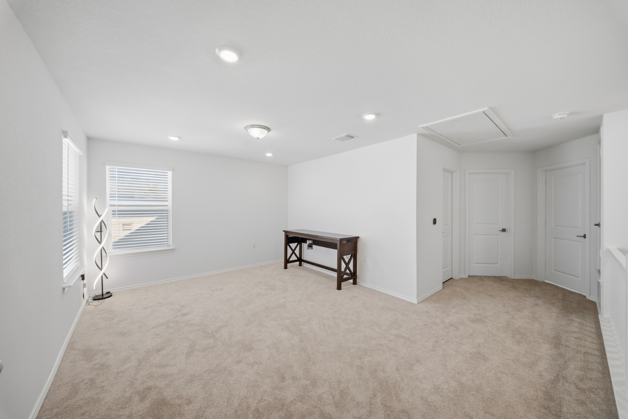 4616 Syndicate Rd Manor Manor, TX 78653 - Photo 8 of 15 A spacious, naturally illuminated room offers plush carpeting, bright recessed lighting, and ample wall space.
