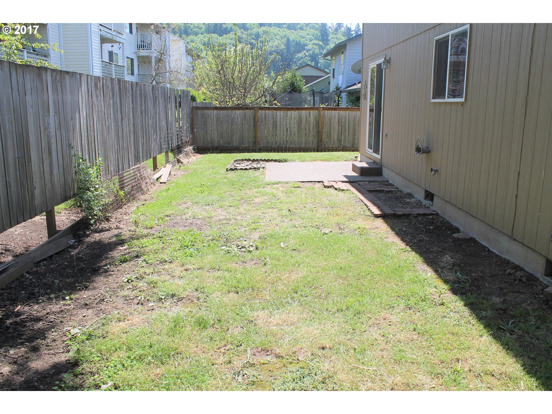 1026 Southwest Ivory Loop Gresham, OR 97080 - Photo 12 of 13 a view of a backyard with wooden fence