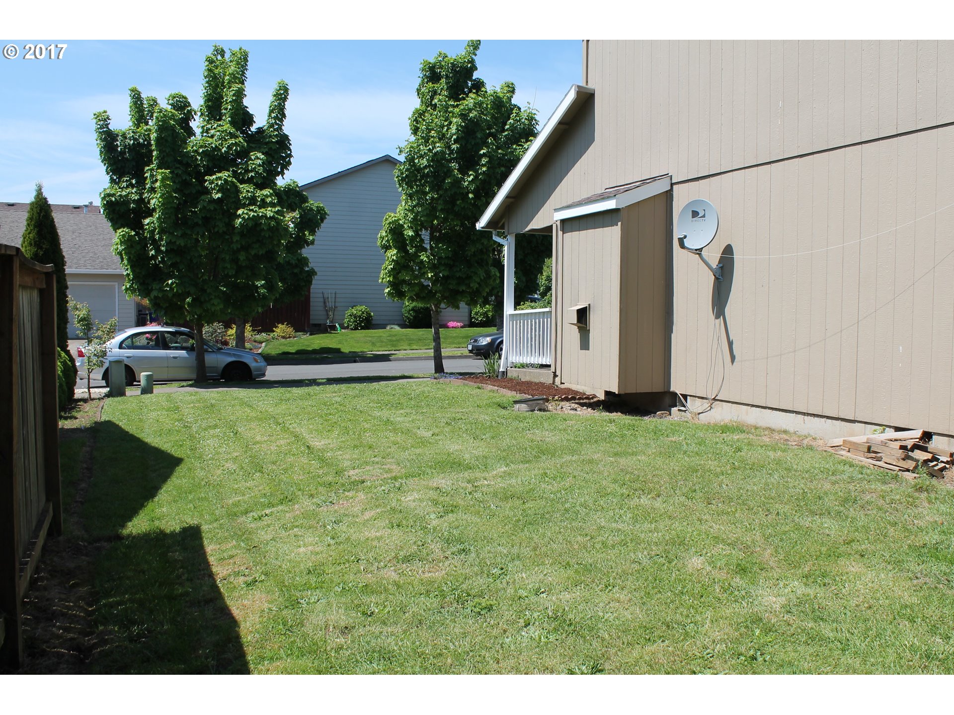1026 Southwest Ivory Loop Gresham, OR 97080 - Photo 13 of 13 a backyard of a house with plants and palm tree