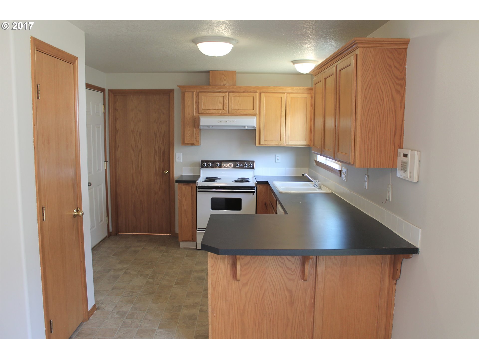 1026 Southwest Ivory Loop Gresham, OR 97080 - Photo 3 of 13 a kitchen with kitchen island a sink stainless steel appliances and cabinets