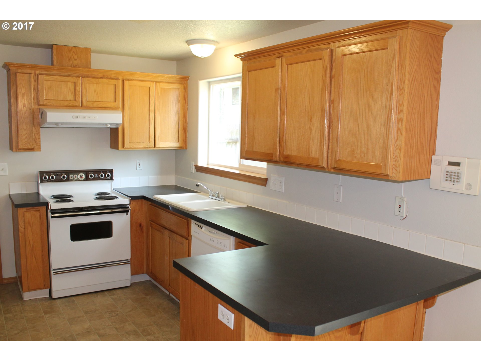 1026 Southwest Ivory Loop Gresham, OR 97080 - Photo 4 of 13 a kitchen with stainless steel appliances cabinets and a window