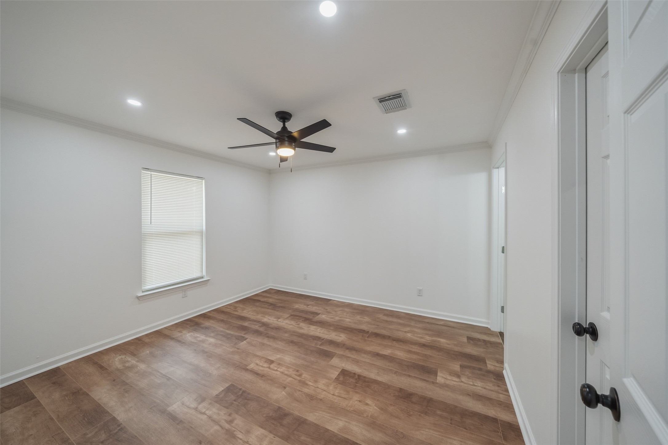 3051 Rothermel Road Houston, TX 77093 - Photo 13 of 24 Spacious primary bedroom featuring a ceiling fan and elegant recessed lighting.