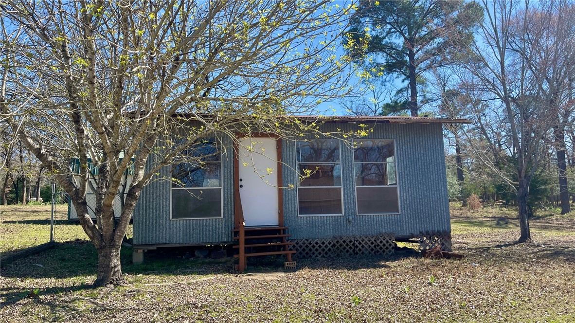 10933 Clyde Acord Road Franklin, TX 77856 - Photo 18 of 20 a front view of a house with garden