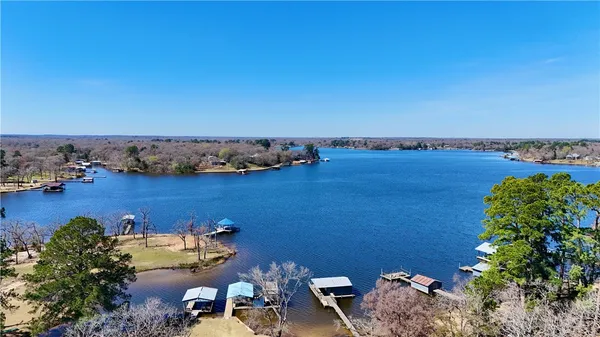an aerial view of a houses with a lake view