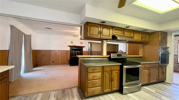 a kitchen with stainless steel appliances granite countertop a stove and a refrigerator