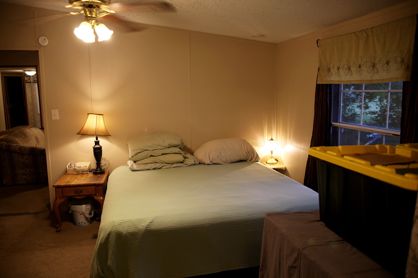 210 Maple Street Adams, TN 37010 - Photo 19 of 35 a bedroom with a bed and a chandelier