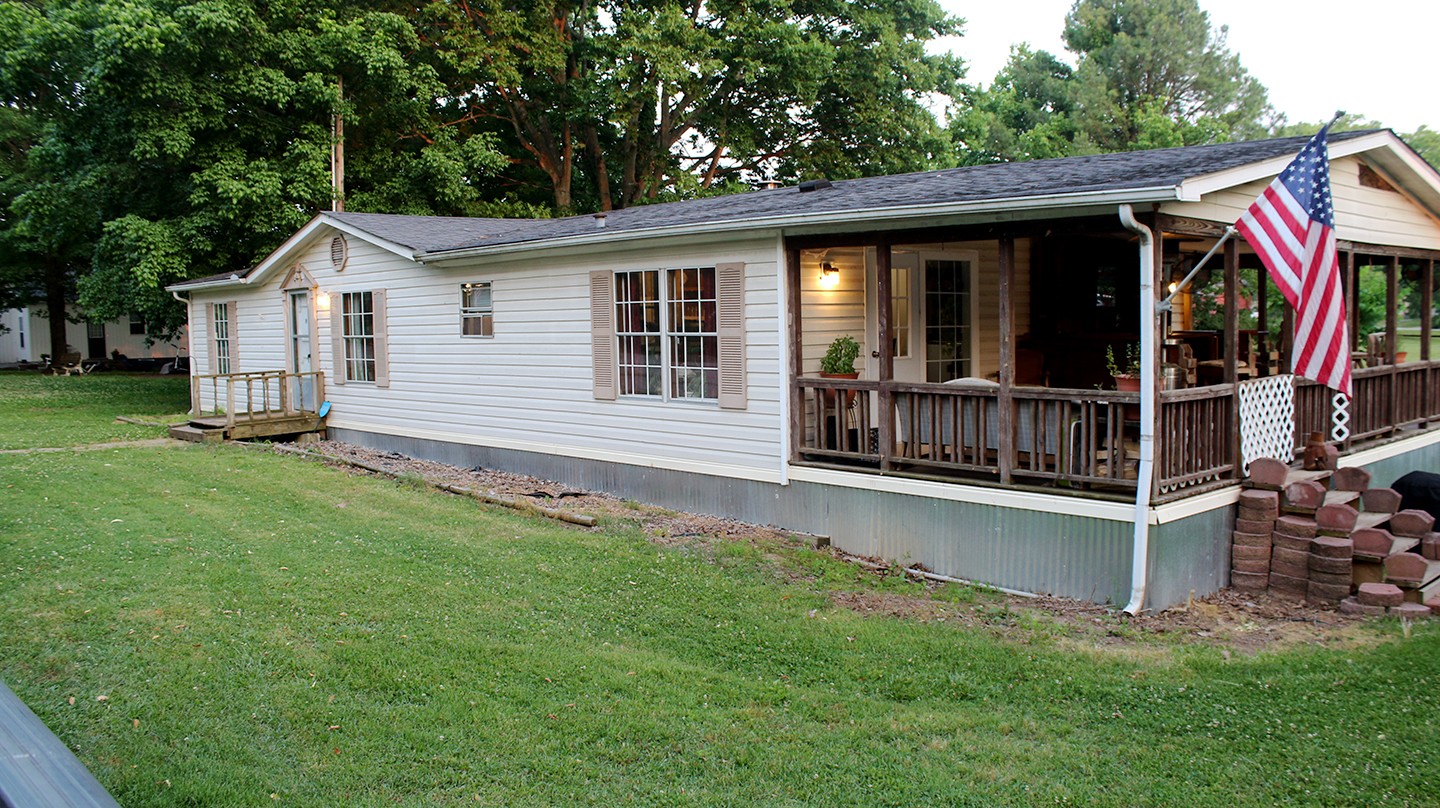 210 Maple Street Adams, TN 37010 - Photo 3 of 35 a view of a house with a yard and deck