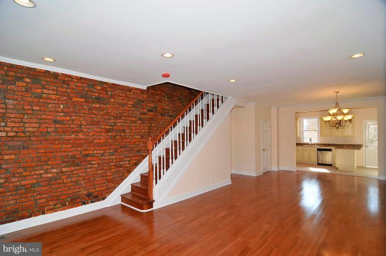 514 Park Road Northwest Washington, DC 20010 - Photo 2 of 15 a view of an empty room with wooden floor and stairs