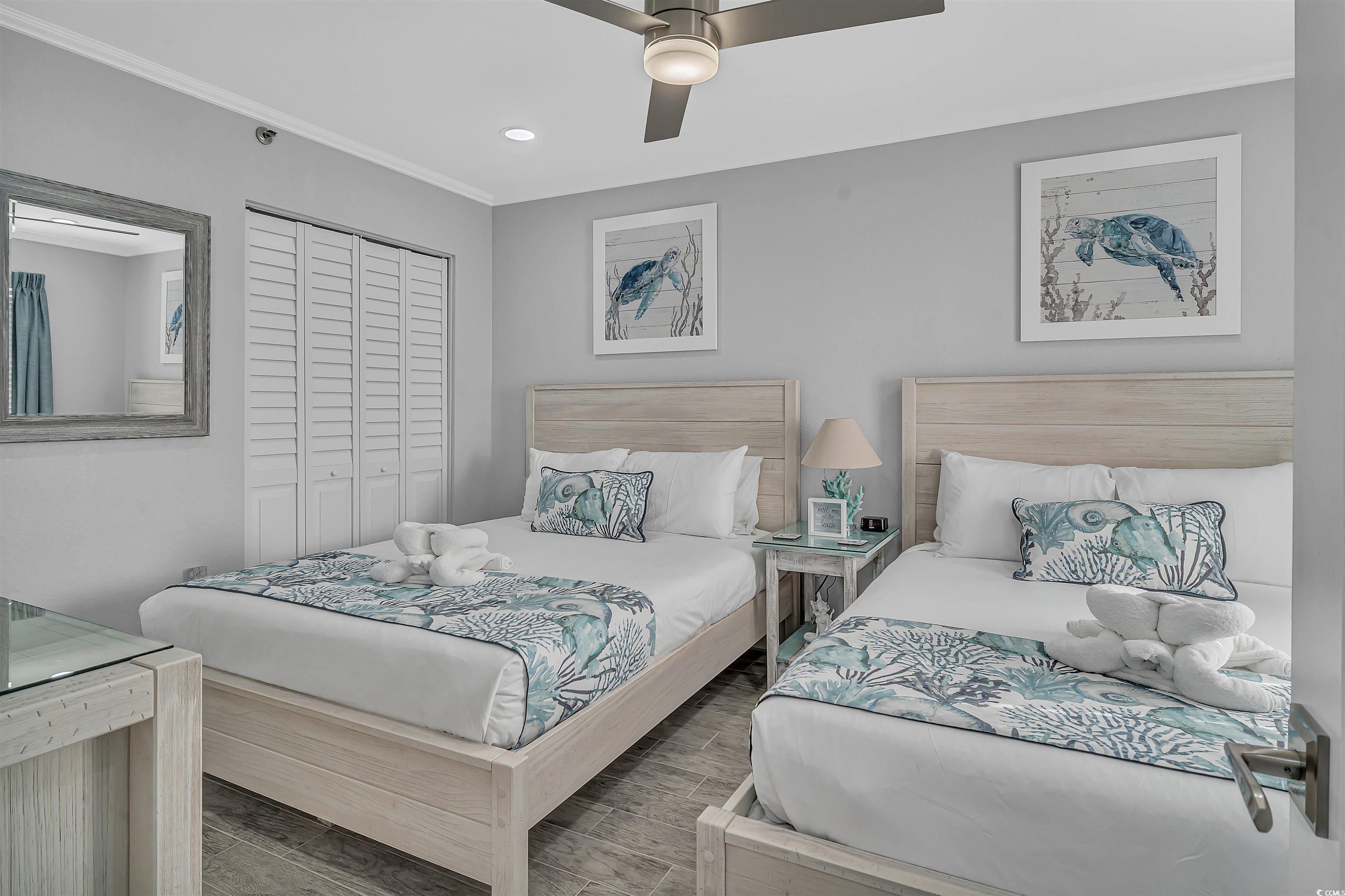 161 Seawatch Drive, Unit 1118 Myrtle Beach, SC 29572 - Photo 13 of 40 Bedroom with a closet, a ceiling fan, crown molding, recessed lighting, and wood finished floors