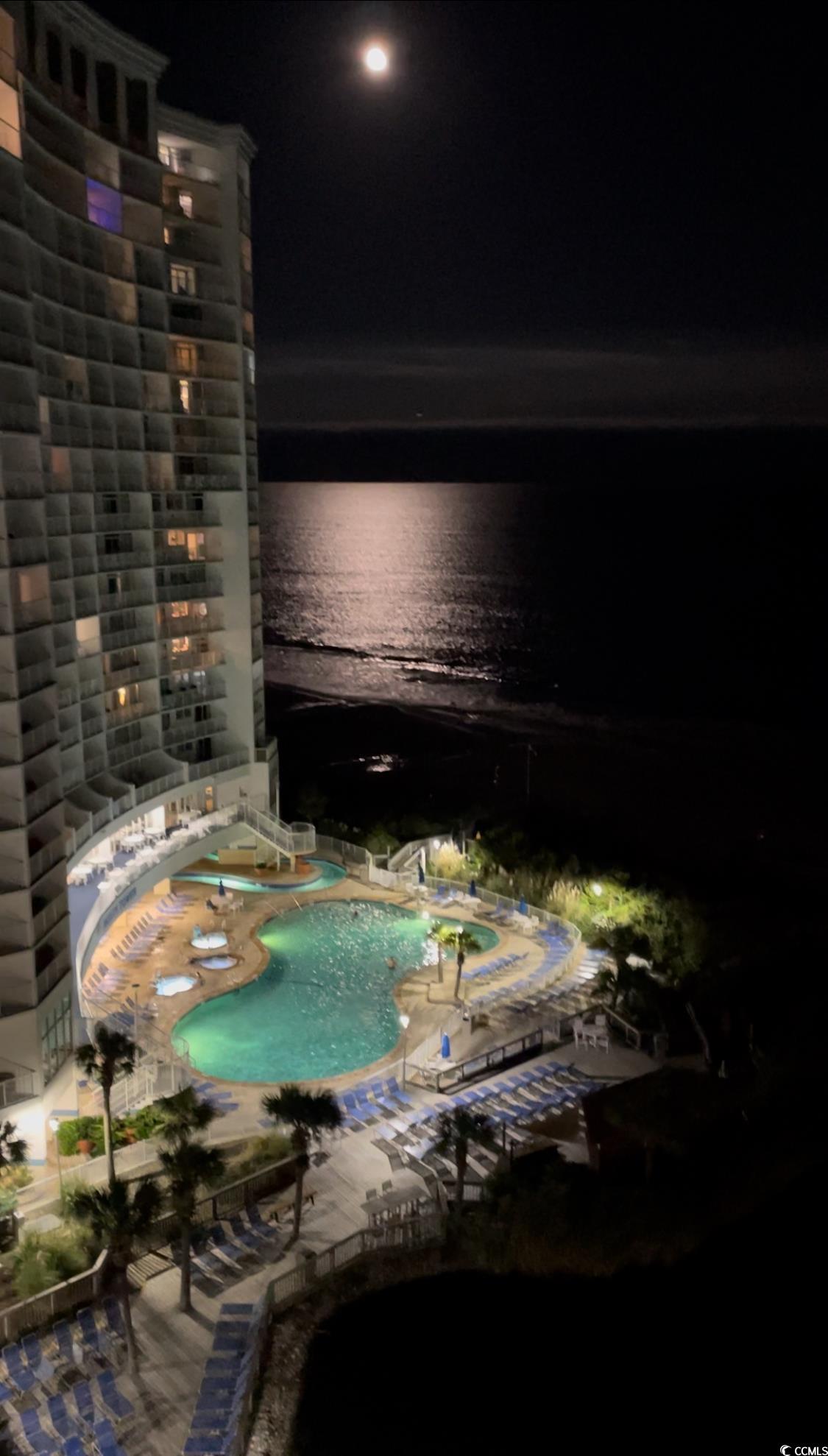 161 Seawatch Drive, Unit 1118 Myrtle Beach, SC 29572 - Photo 23 of 40 Pool at night featuring a community pool