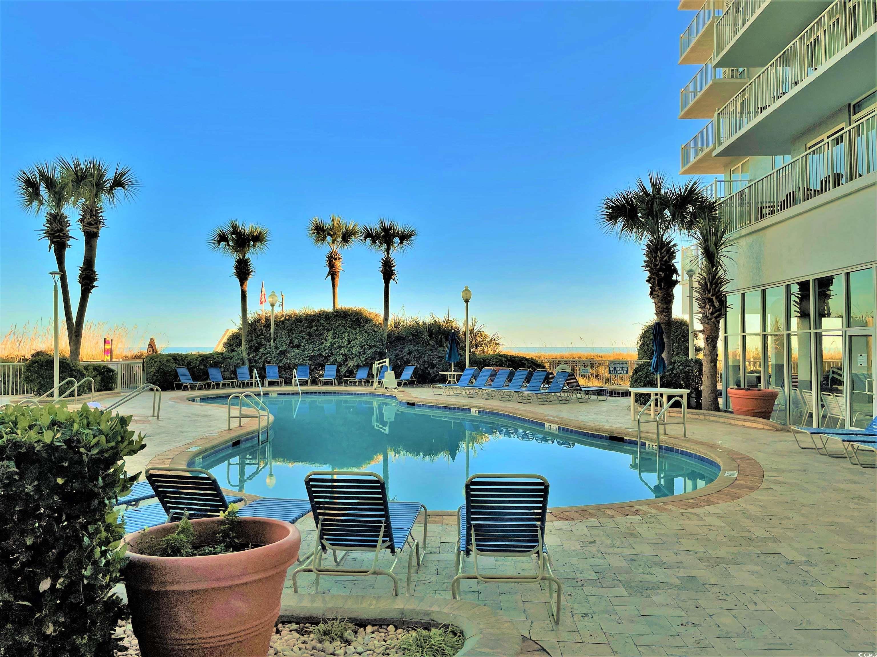 161 Seawatch Drive, Unit 1118 Myrtle Beach, SC 29572 - Photo 27 of 40 Community pool featuring a patio area