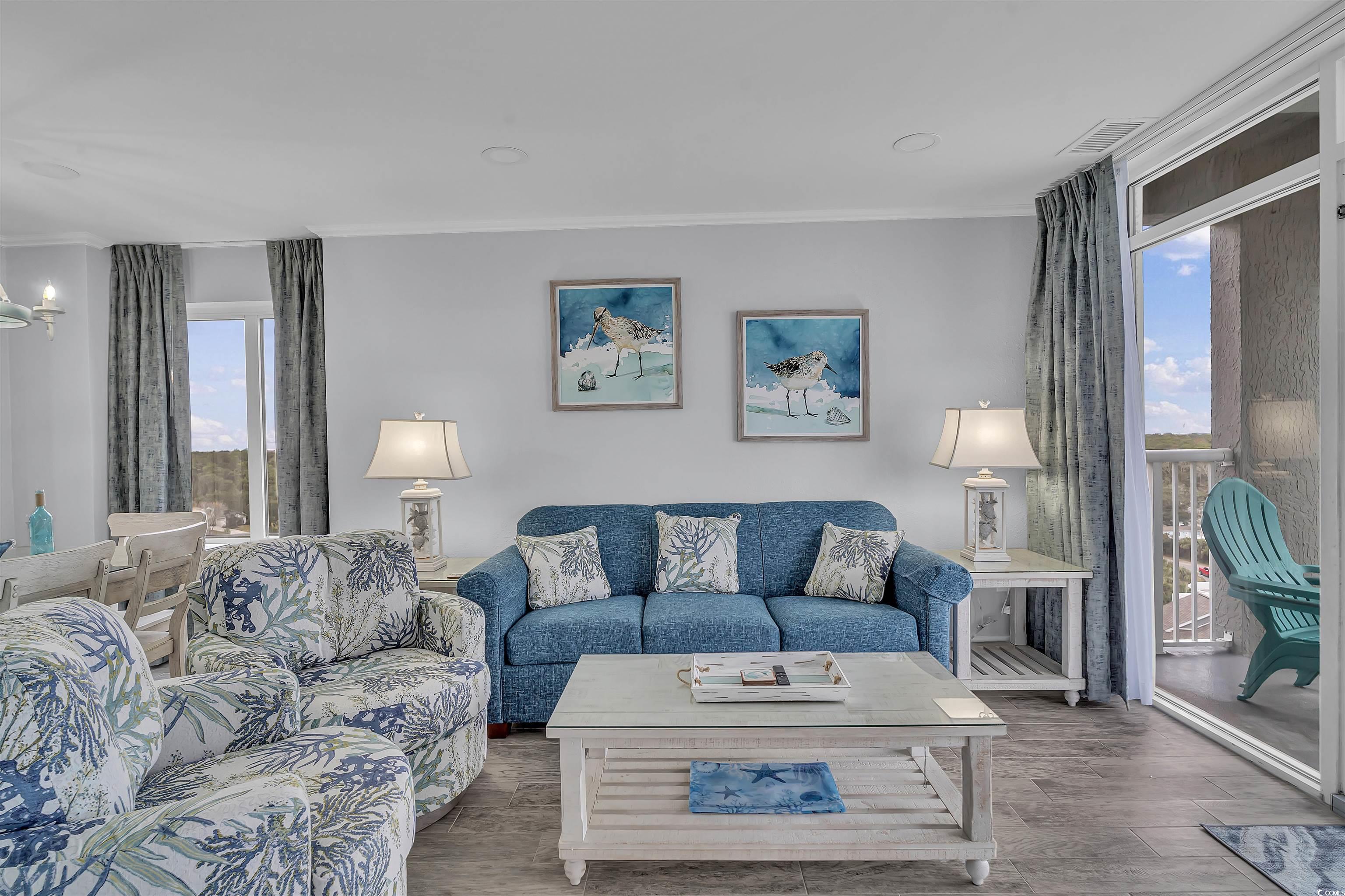 161 Seawatch Drive, Unit 1118 Myrtle Beach, SC 29572 - Photo 7 of 40 Living area featuring crown molding and wood finished floors