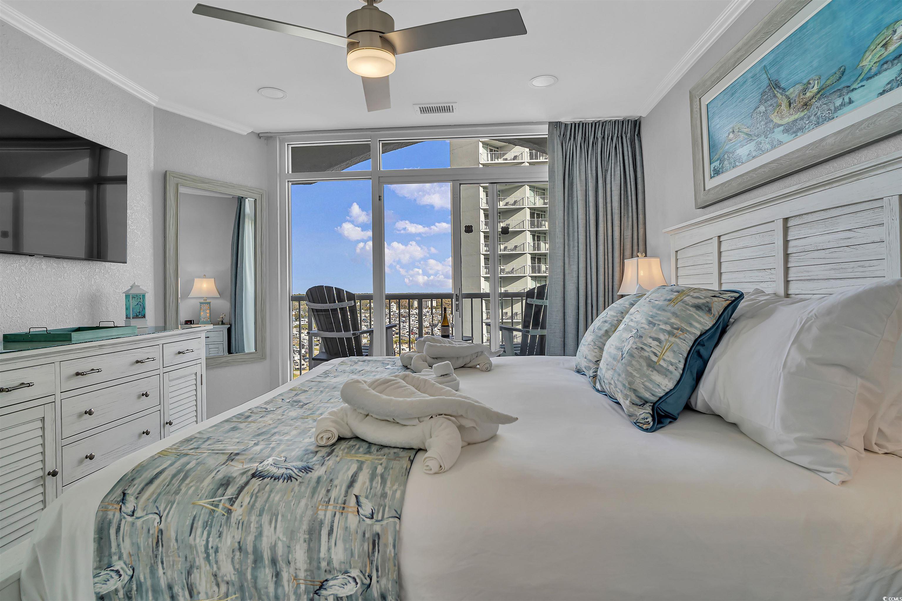 161 Seawatch Drive, Unit 1118 Myrtle Beach, SC 29572 - Photo 10 of 40 Bedroom featuring ornamental molding, a ceiling fan, and access to outside