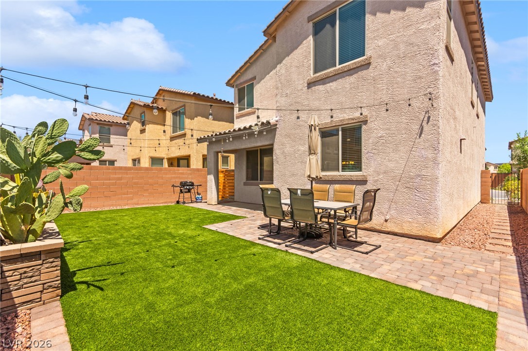 6435 Point Isabel Way Las Vegas, NV 89122 - Photo 48 of 57 Enjoy outdoor living with a private yard featuring artificial turf and a shaded patio area.