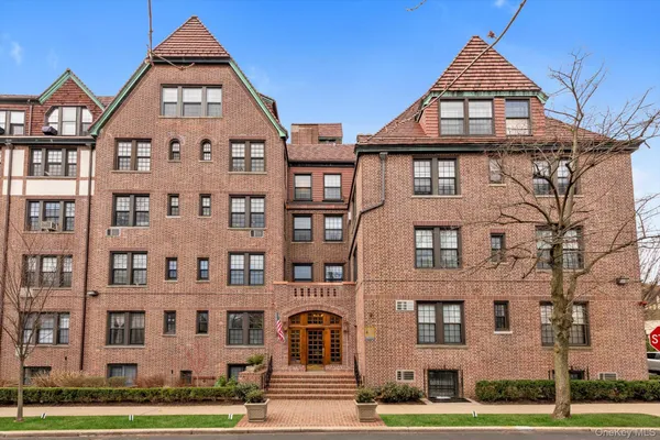 a view of a brick building next to a yard