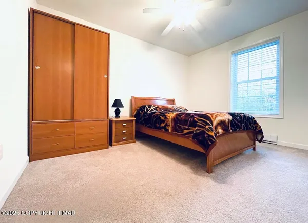 a bed sitting in a bedroom next to a window