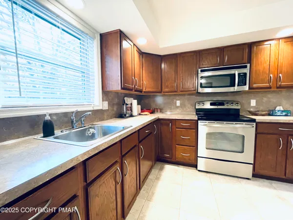 a kitchen with a sink stove and microwave