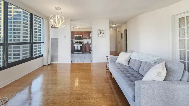 a living room with furniture and a floor to ceiling window