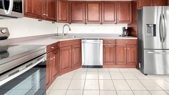 a kitchen with stainless steel appliances granite countertop a sink stove and microwave