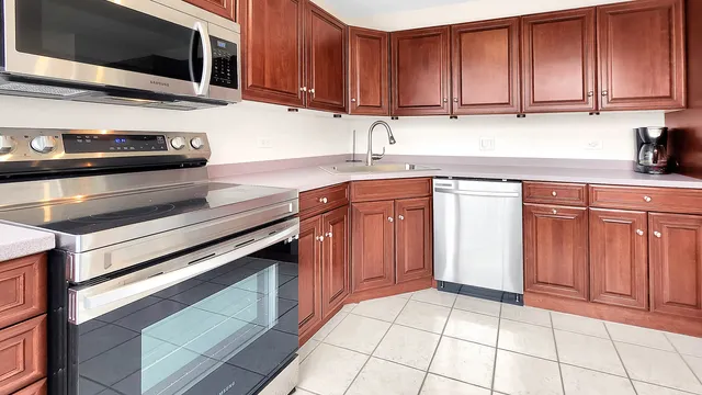 a kitchen with stainless steel appliances granite countertop a stove microwave and cabinets
