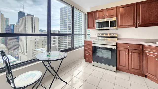 a kitchen with a table chairs and stove