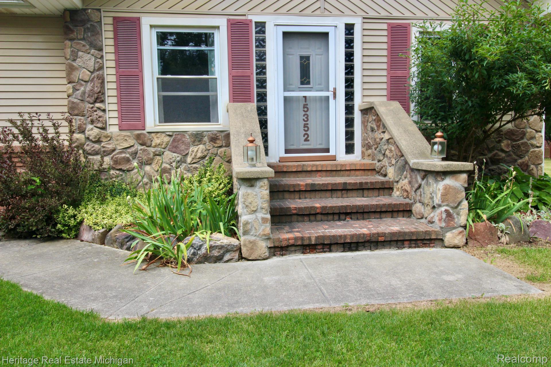 15352 South Duffield Road Byron, MI 48418 - Photo 43 of 47 Stone and siding exterior with brick stairs and concrete walkways
