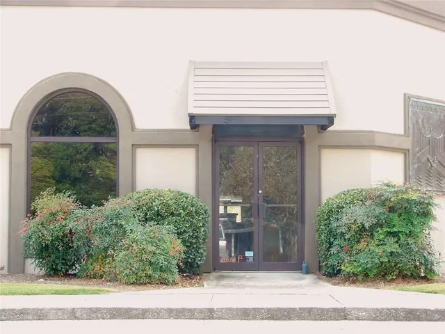 a view of a brick house with a large windows