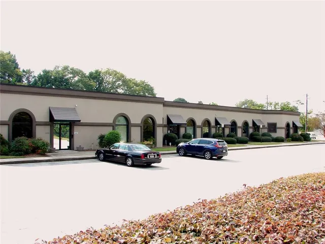 a view of house with outdoor space and car parked