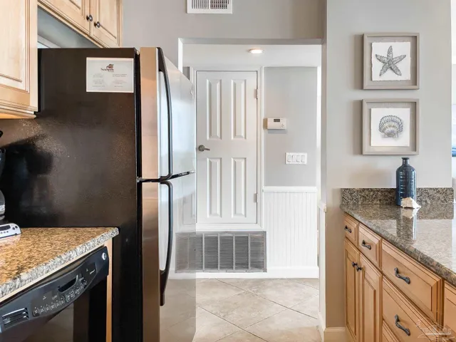 a kitchen with stainless steel appliances granite countertop a refrigerator and a stove