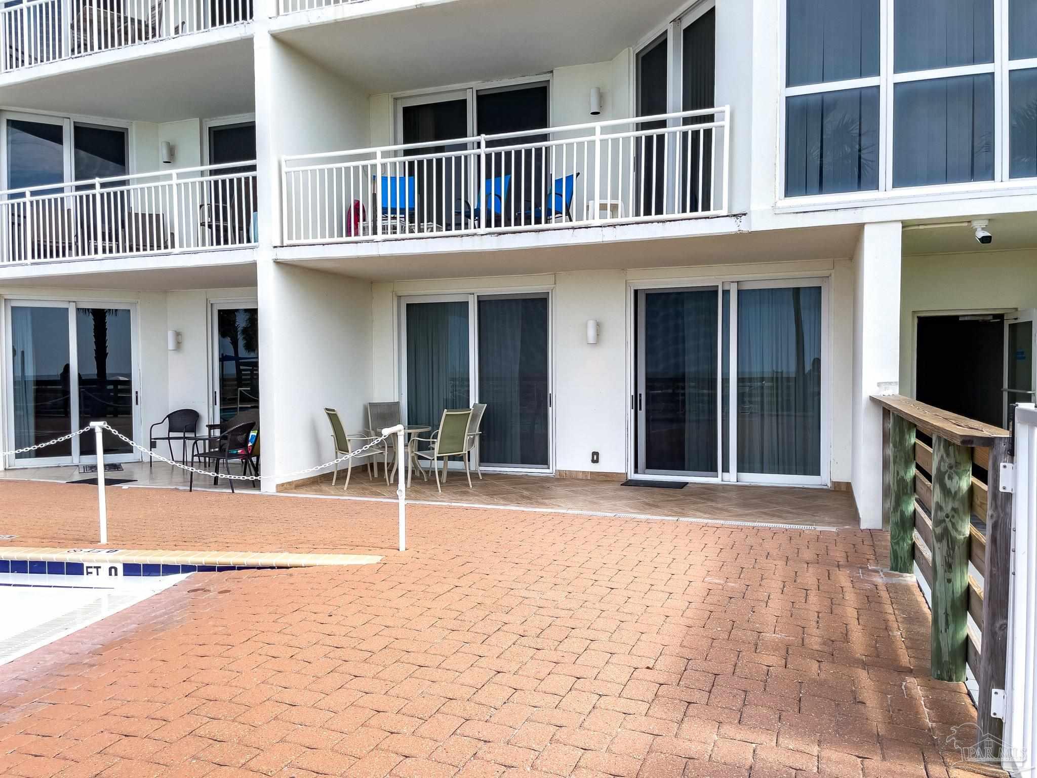 16287 Perdido Key Drive, Unit 104 Pensacola, FL 32507 - Photo 21 of 32 a front view of a house with swimming pool and furniture