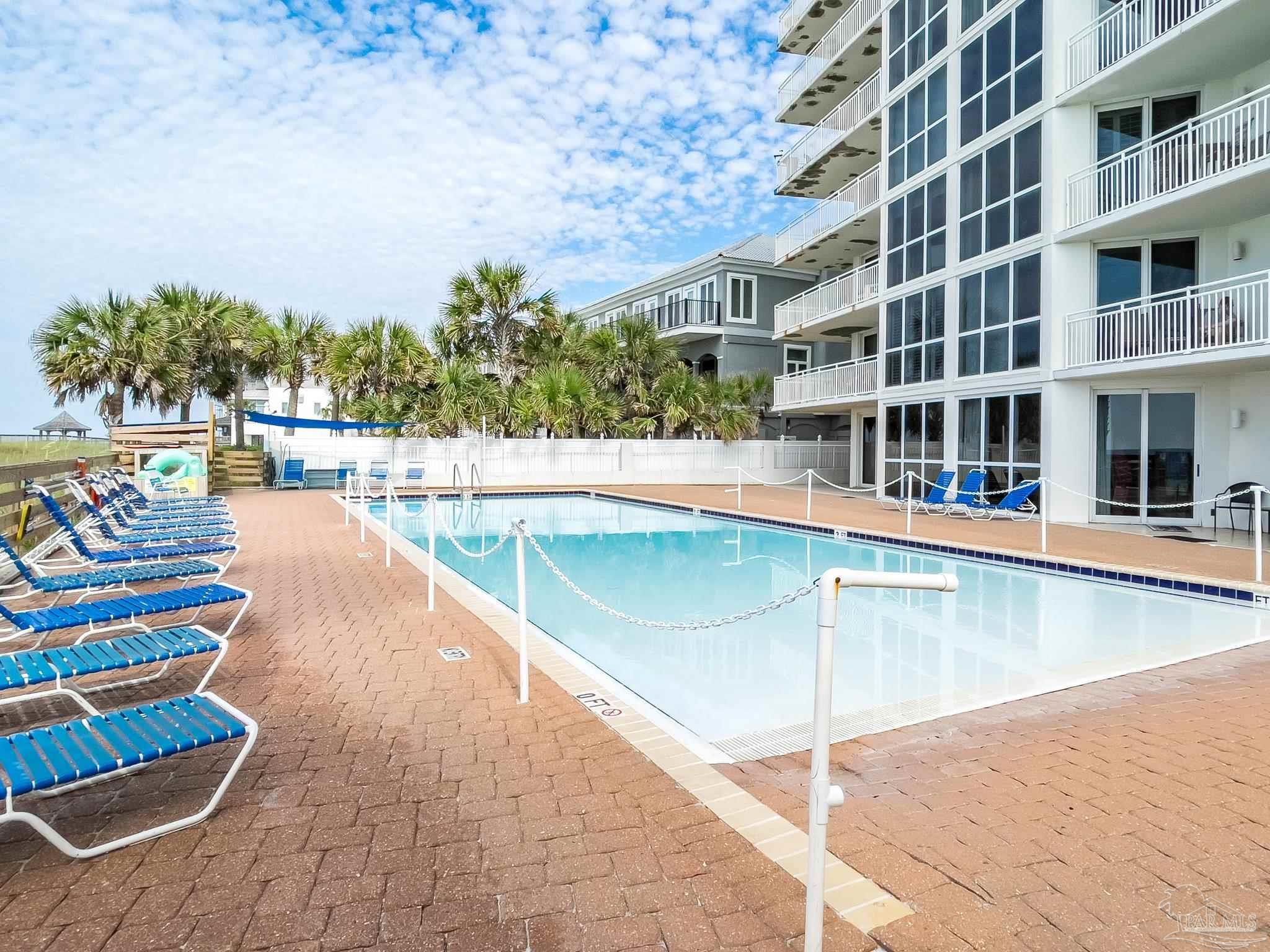 16287 Perdido Key Drive, Unit 104 Pensacola, FL 32507 - Photo 23 of 32 a view of a swimming pool and an outdoor seating