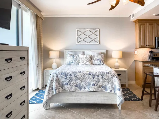 a bed sitting in a bedroom next to a lamp