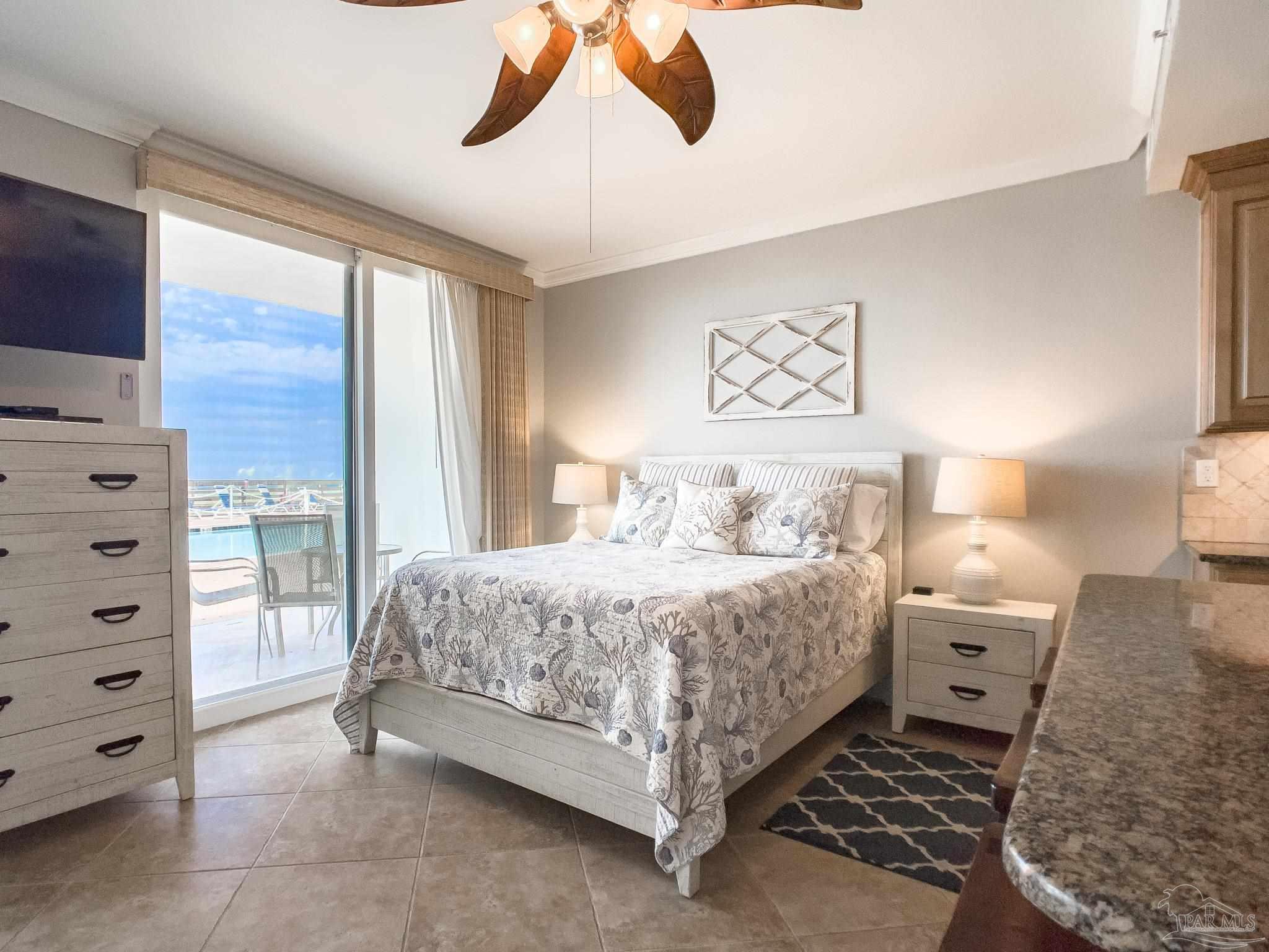 16287 Perdido Key Drive, Unit 104 Pensacola, FL 32507 - Photo 9 of 32 a spacious bedroom with a bed and a window