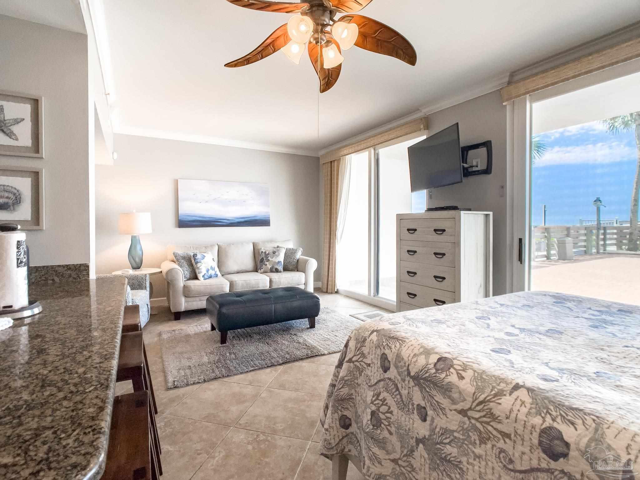 16287 Perdido Key Drive, Unit 104 Pensacola, FL 32507 - Photo 10 of 32 a bedroom with a bed couch and window