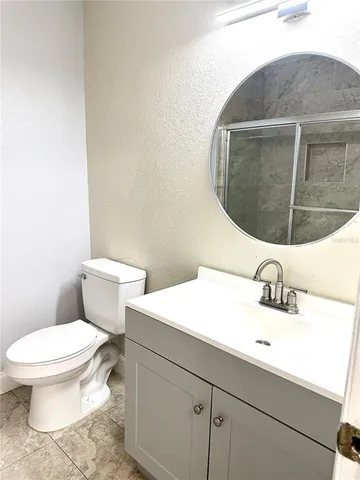a bathroom with a sink toilet and mirror