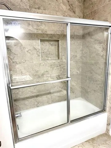 a bathroom with a glass shower door