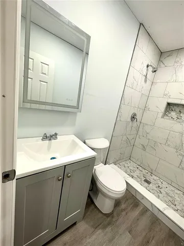 a bathroom with a toilet sink and shower