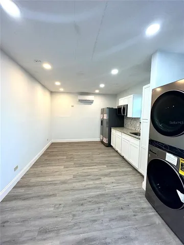 a view of a kitchen with a sink cabinets and wooden floor