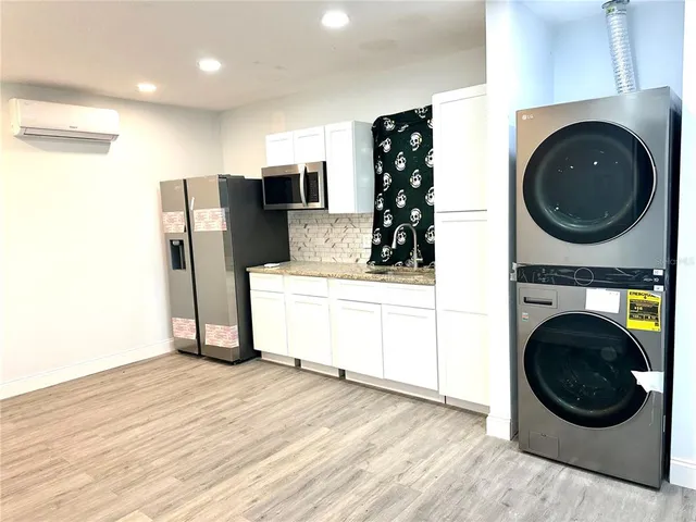 a view of a kitchen with washer and dryer