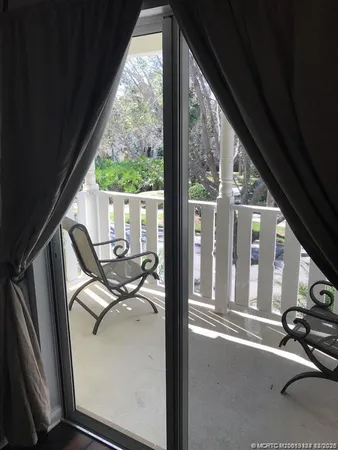 a view of balcony with wooden floor and fence