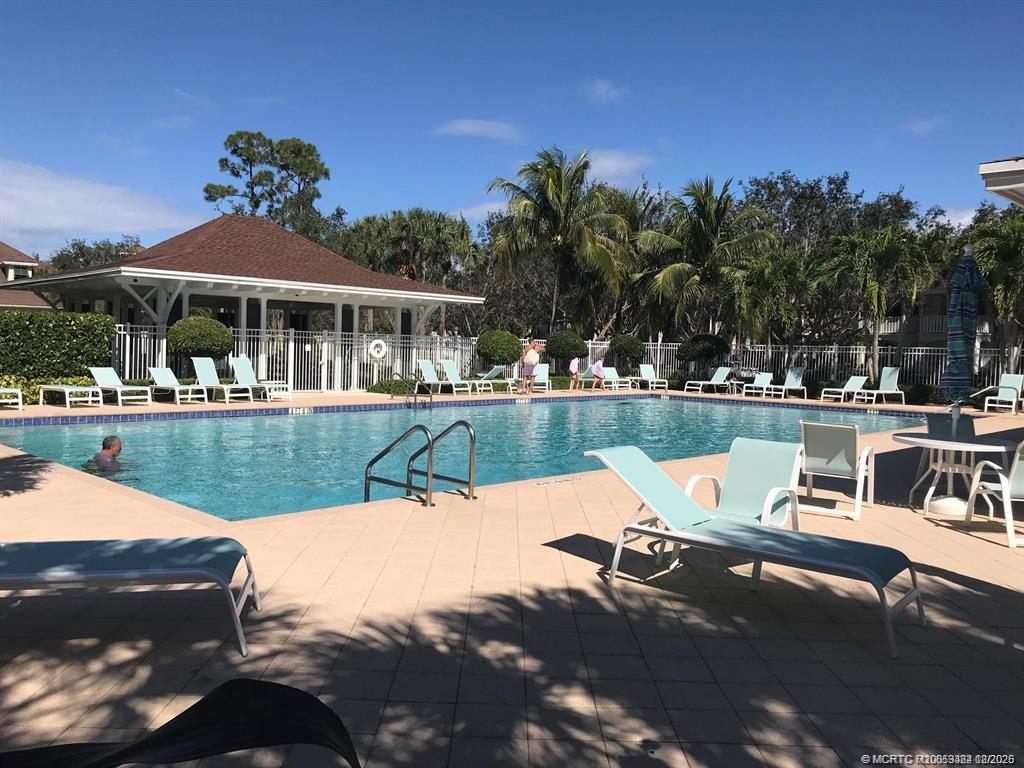 2977 East Community Drive Jupiter, FL 33458 - Photo 14 of 15 a view of a swimming pool with a patio