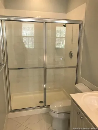 a bathroom with a shower and a toilet