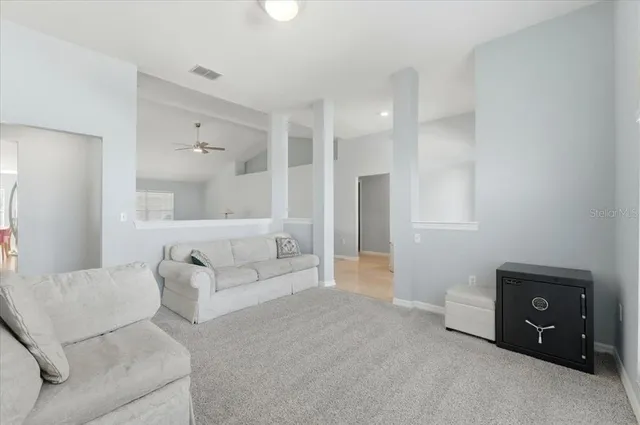 a living room with furniture and a bathroom
