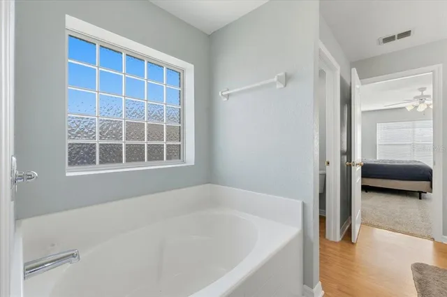 a bathroom with a bathtub and a shower