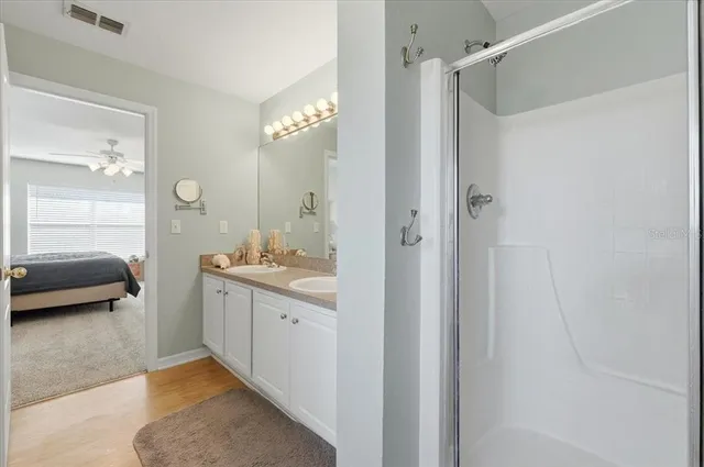 a en suite bathroom with a sink a mirror and a shower