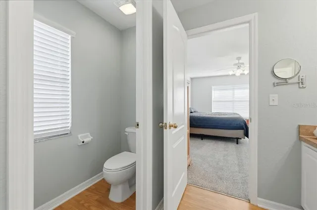 a en suite bathroom with a toilet a sink and a mirror